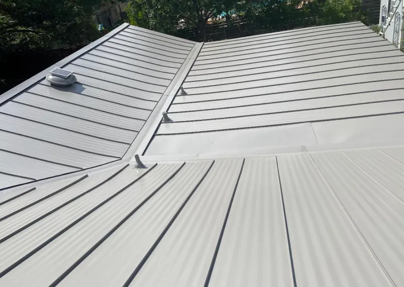 Solar attic fan installed on a metal roof for Roof Ventilation in Long Branch